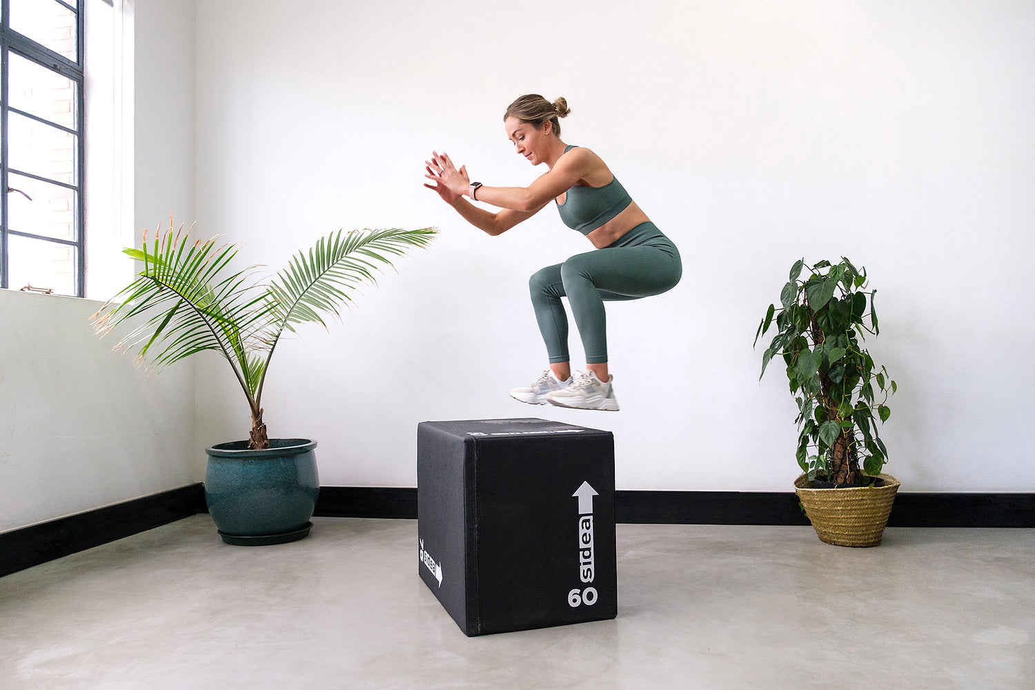 Coach Cords (Daniella Corder) doing a box jump onto a "side a" branded box.